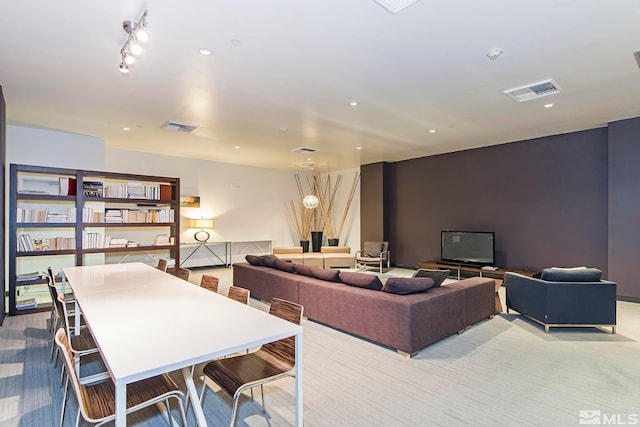 living area with light carpet, visible vents, and recessed lighting