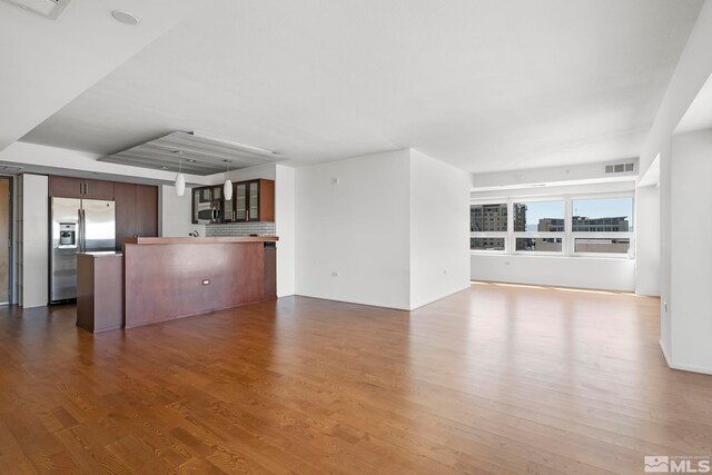 unfurnished living room with wood-type flooring