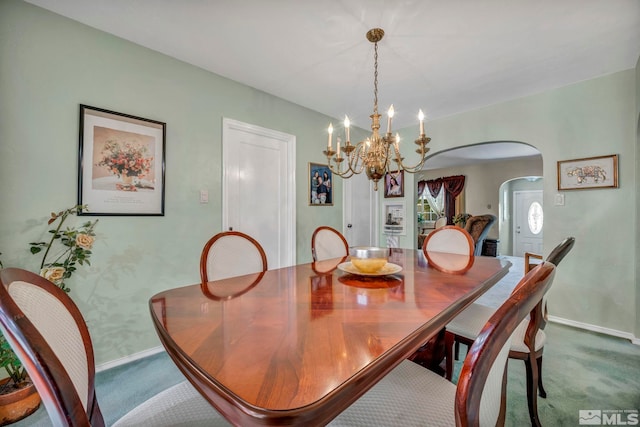 dining room with a notable chandelier and carpet floors