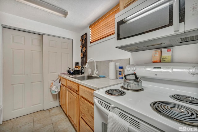 kitchen with a textured ceiling, light tile patterned flooring, sink, and white electric stove