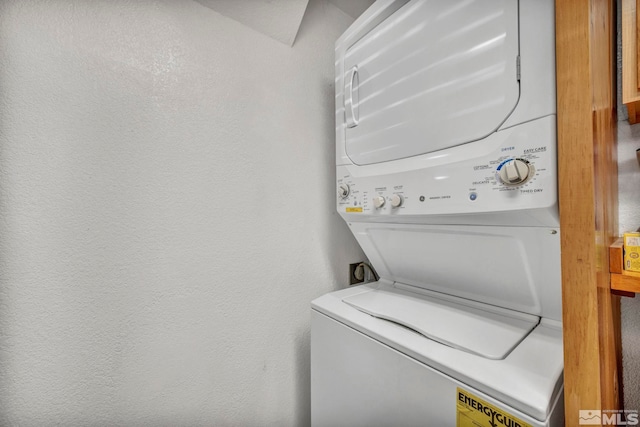 laundry room with stacked washing maching and dryer