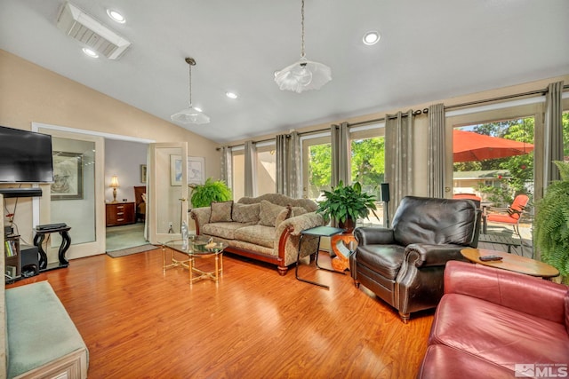 living room with light hardwood / wood-style flooring and lofted ceiling