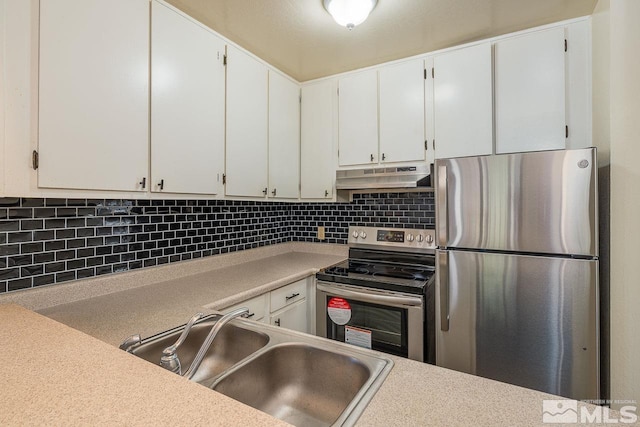 kitchen with decorative backsplash, sink, white cabinets, and appliances with stainless steel finishes