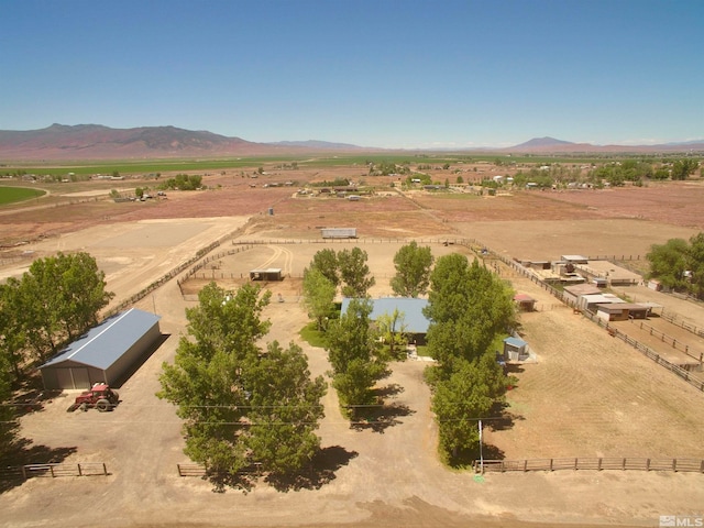 drone / aerial view featuring a mountain view and a rural view