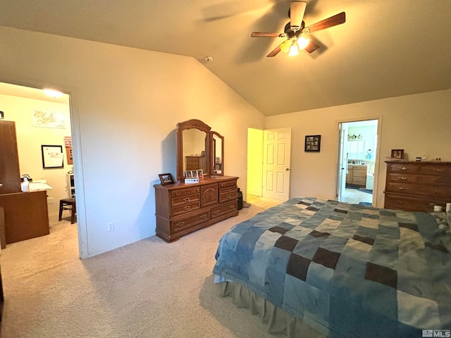 bedroom with light carpet, lofted ceiling, ceiling fan, and ensuite bath