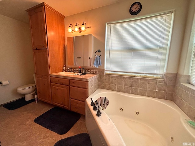 bathroom featuring a healthy amount of sunlight, tile flooring, vanity, and toilet