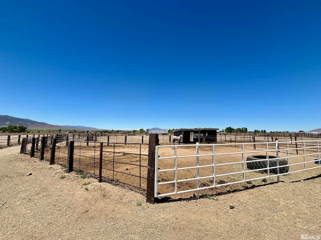 view of horse barn with a rural view