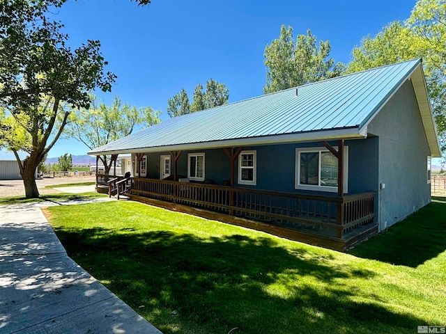 view of front of house with a front yard and a porch