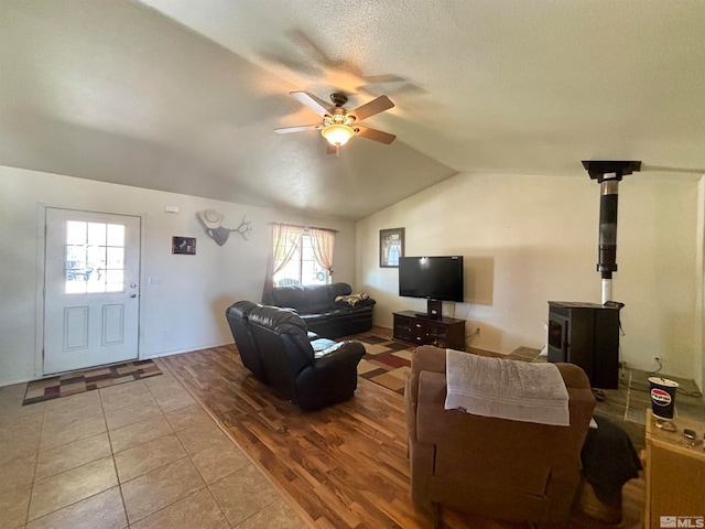 tiled living room with lofted ceiling and ceiling fan