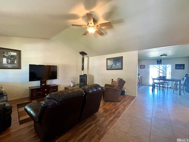 living room featuring tile floors, lofted ceiling, and ceiling fan