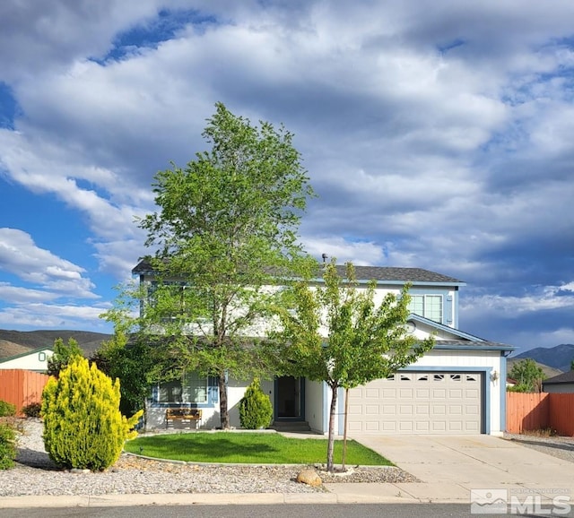 obstructed view of property featuring a garage and a mountain view