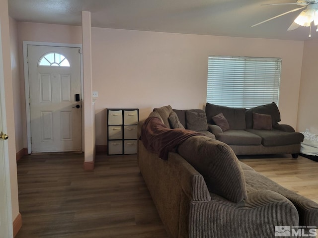 living room featuring wood-type flooring and ceiling fan