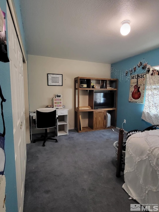 bedroom with dark carpet, a closet, and a textured ceiling