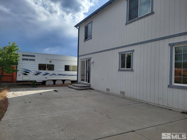 view of side of property with a patio