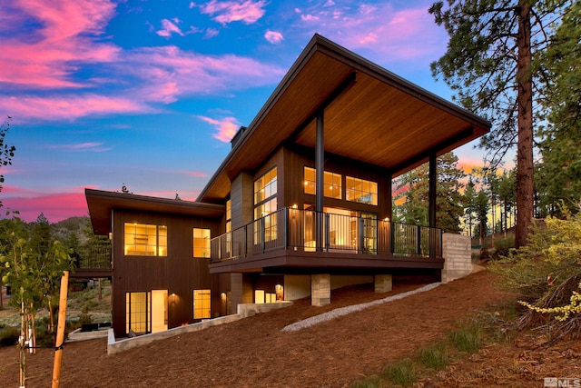 view of back house at dusk