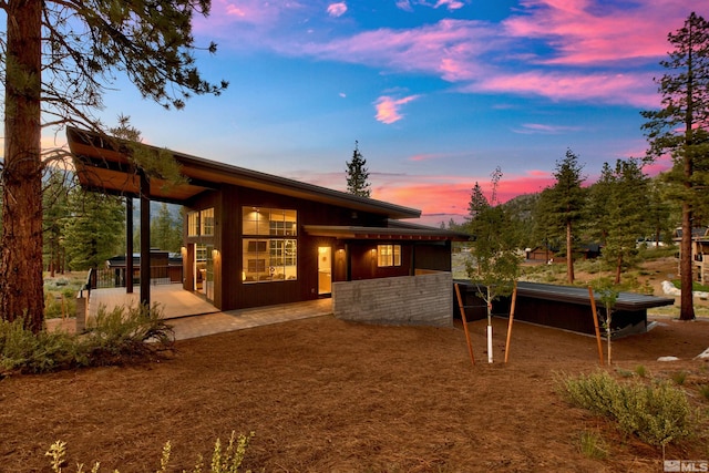 view of back house at dusk