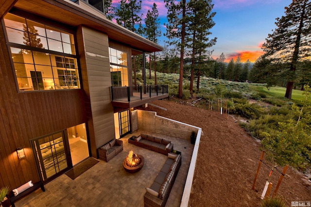 patio terrace at dusk with a fire pit