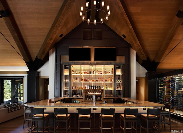 bar featuring beam ceiling, wood ceiling, stone countertops, and a notable chandelier