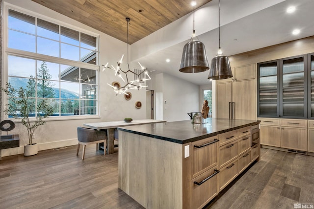 kitchen with light brown cabinets, a kitchen island, wood ceiling, and decorative light fixtures