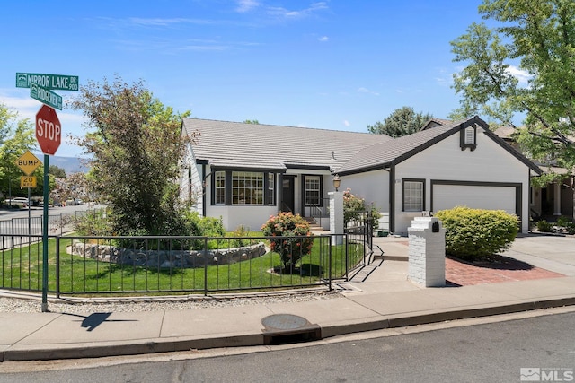 single story home featuring a garage and a front lawn