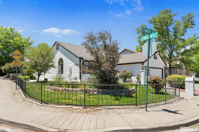 view of front of home with a garage and a front lawn