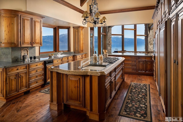 kitchen with dark hardwood / wood-style flooring, a water and mountain view, tasteful backsplash, and a kitchen island