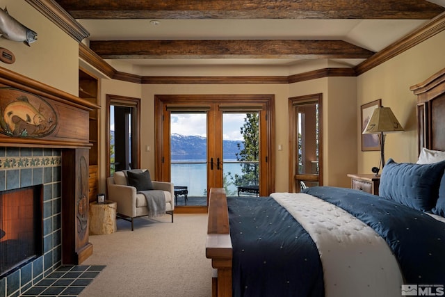 bedroom with a tile fireplace, dark colored carpet, access to outside, a mountain view, and french doors