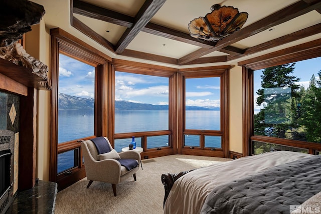 carpeted bedroom with a water and mountain view, coffered ceiling, and beam ceiling