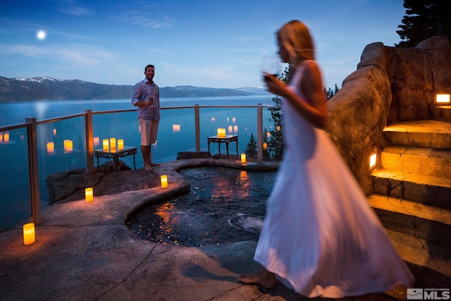 view of pool with a water and mountain view