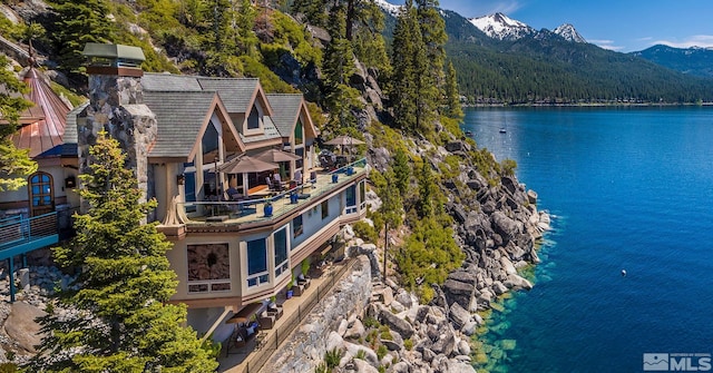 birds eye view of property featuring a water and mountain view