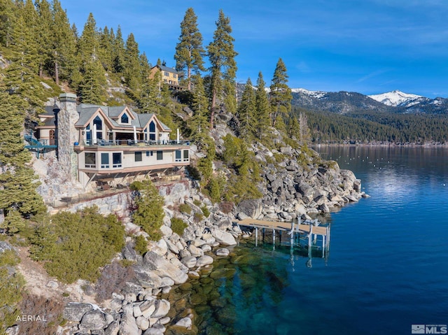 birds eye view of property featuring a water and mountain view