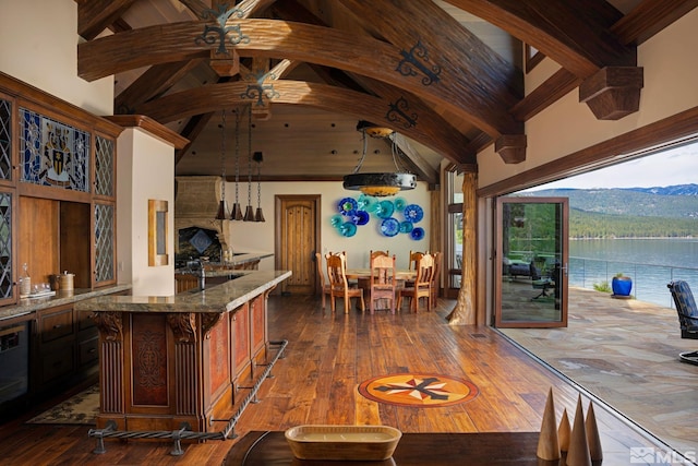 kitchen featuring beamed ceiling, high vaulted ceiling, hardwood / wood-style floors, and hanging light fixtures