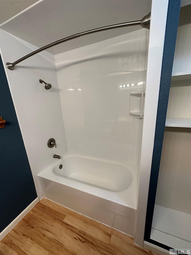 bathroom with shower / bathtub combination and wood-type flooring