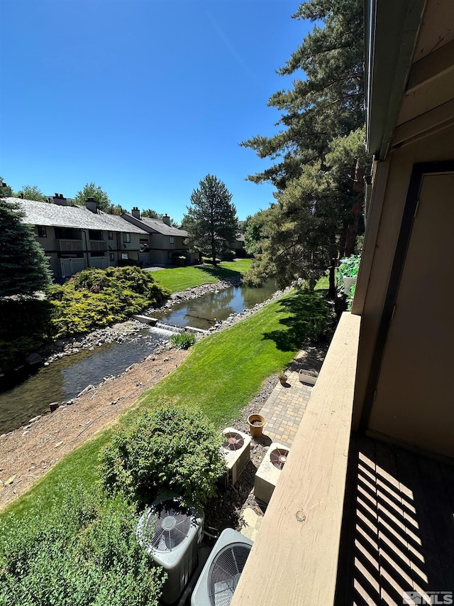 view of yard featuring ac unit and a water view