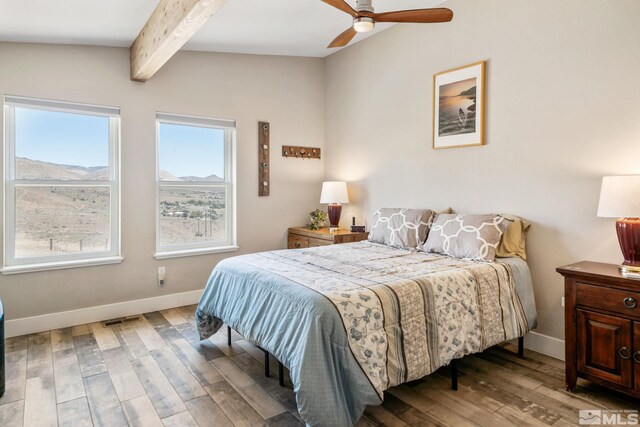 bedroom featuring hardwood / wood-style floors, lofted ceiling with beams, and ceiling fan