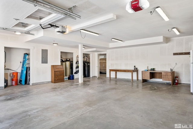 garage featuring white refrigerator, a garage door opener, and electric panel