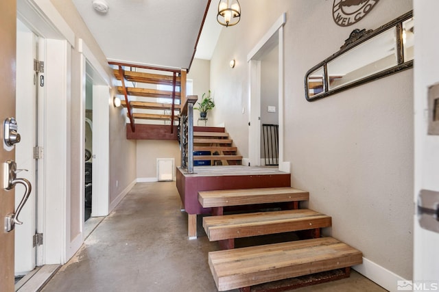 stairway featuring concrete flooring