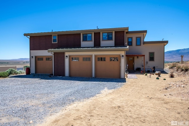 view of front of home with a mountain view and a garage