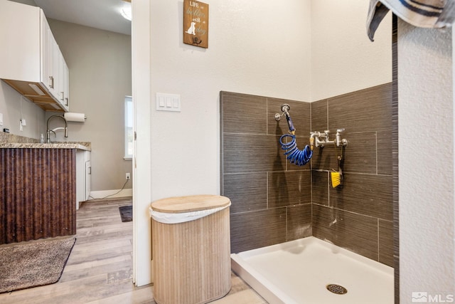 bathroom featuring vanity, wood-type flooring, and walk in shower