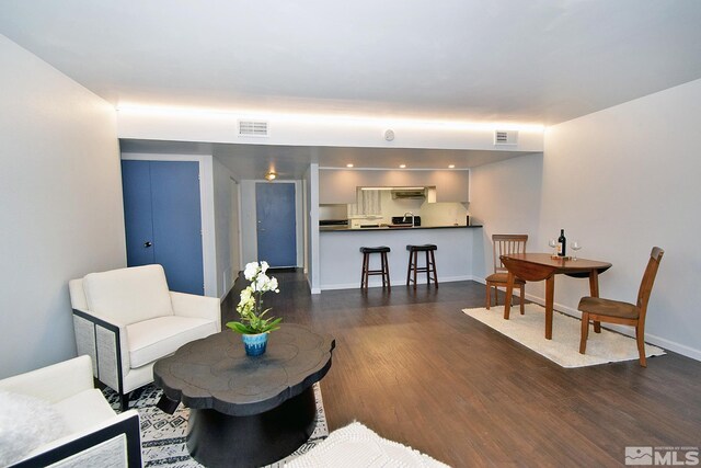 living room with dark hardwood / wood-style flooring