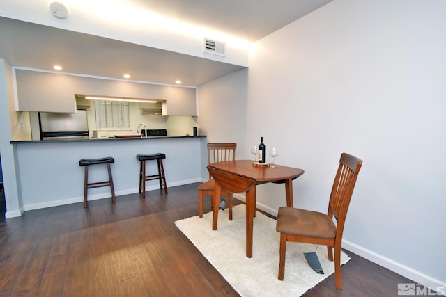 dining area with dark hardwood / wood-style floors