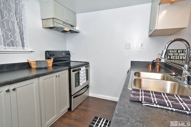 kitchen featuring sink, electric range, and dark hardwood / wood-style floors