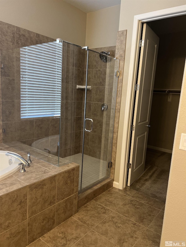 bathroom featuring tile patterned flooring and independent shower and bath