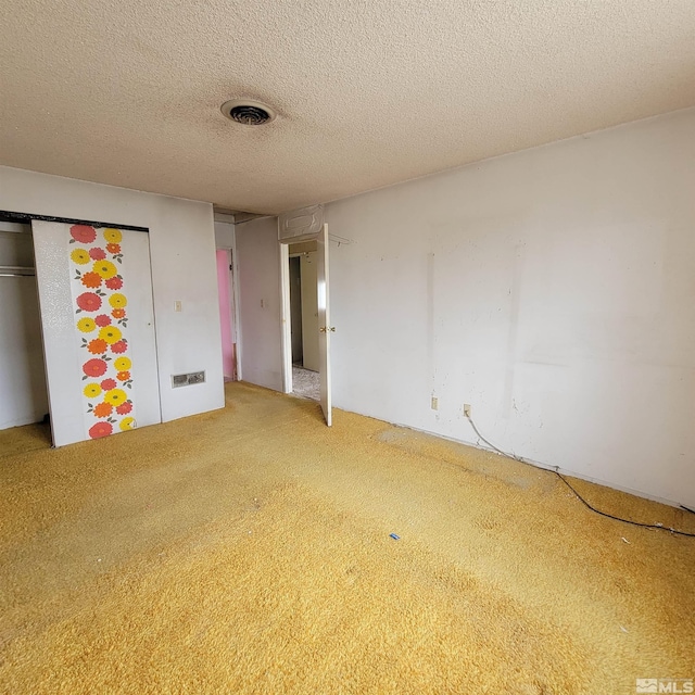 unfurnished bedroom with a closet, a textured ceiling, and carpet