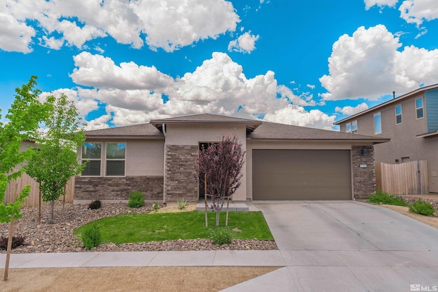 prairie-style home featuring a front lawn and a garage