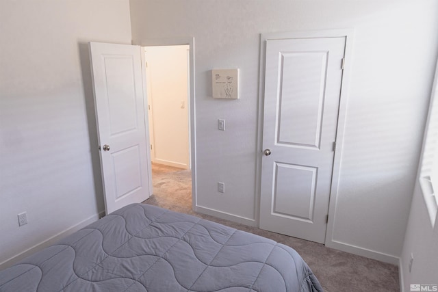 bedroom featuring a closet and light colored carpet