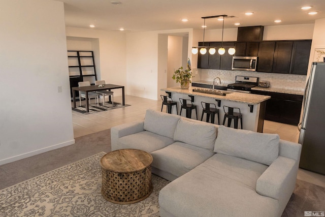 living room with light tile patterned floors and sink