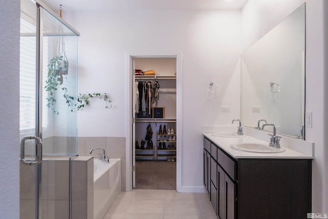 bathroom with tile patterned flooring, vanity, and separate shower and tub