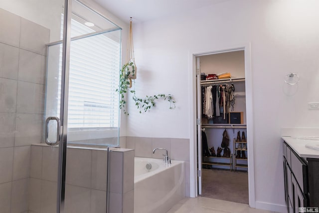 bathroom featuring tile patterned flooring, vanity, and independent shower and bath