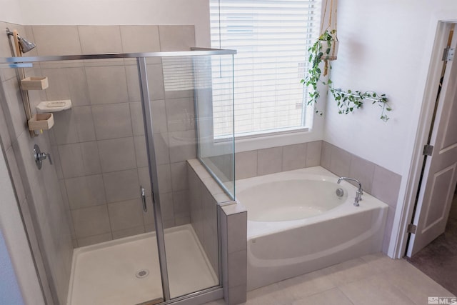 bathroom featuring tile patterned flooring and independent shower and bath